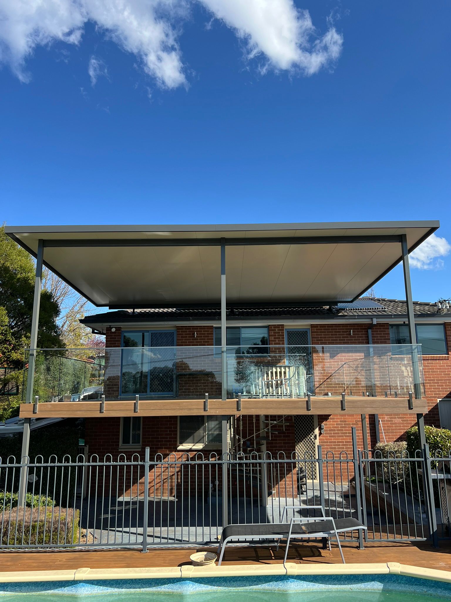 Pergola over composite deck with glass balustrade, Latham Canberra
